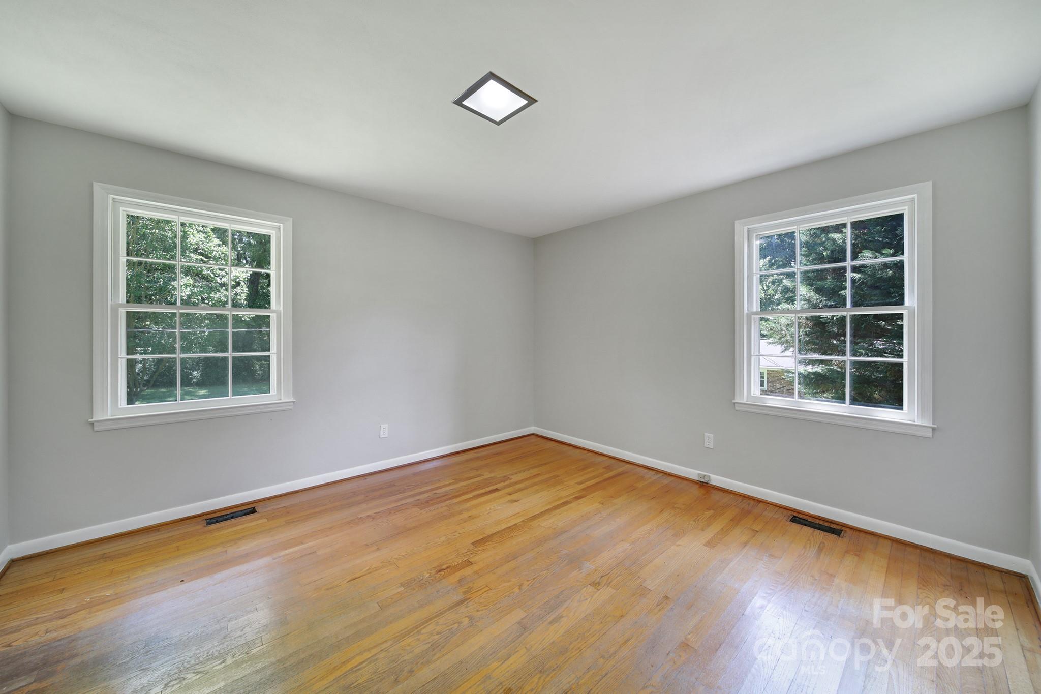 967 State Rd S-29-376 Lancaster, SC 29720 - Photo 23 of 33 an empty room with wooden floor and windows