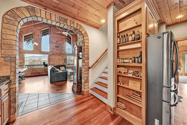 a view of a livingroom with furniture wooden floor and windows