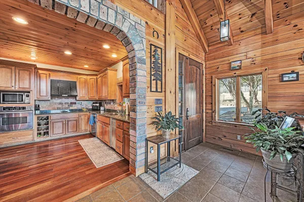 a kitchen with stainless steel appliances granite countertop a refrigerator and a stove top oven