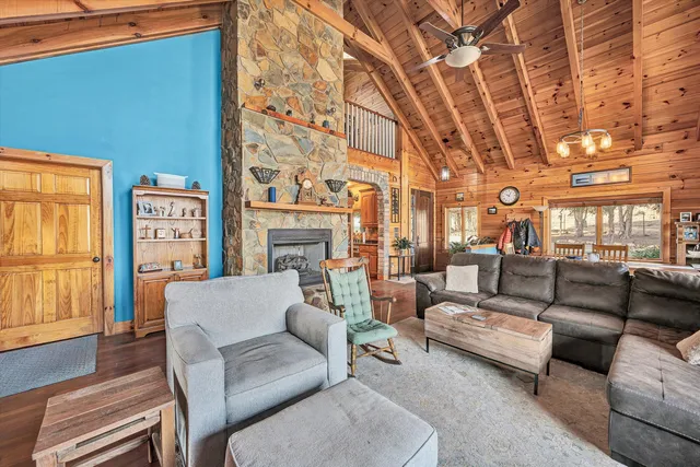 a view of a balcony with wooden floor next to a yard