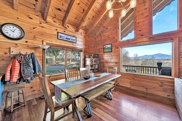 a view of a balcony with wooden floor next to a yard