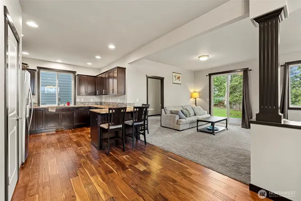 a living room with furniture dining table and a large window