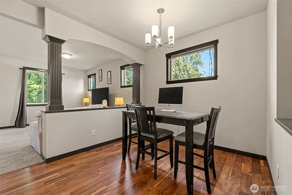 a view of a dining room with furniture and wooden floor