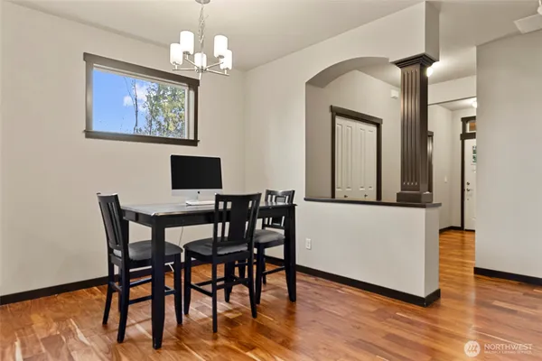 a view of a dining room with furniture wooden floor and a chandelier