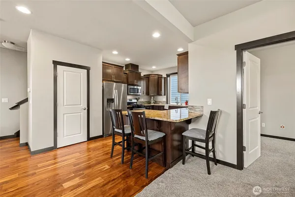 a view of a dining room with furniture and wooden floor