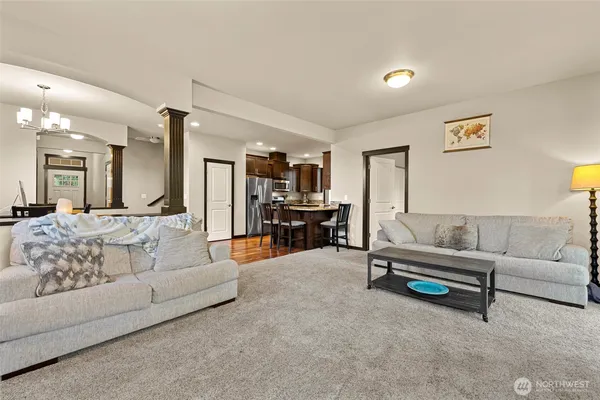 a living room with furniture and kitchen view