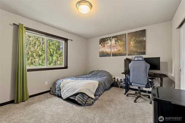 a bedroom with a bed and windows