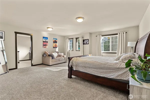 a spacious bedroom with a bed and a couch