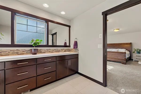 a en suite bathroom with a sink and a mirror