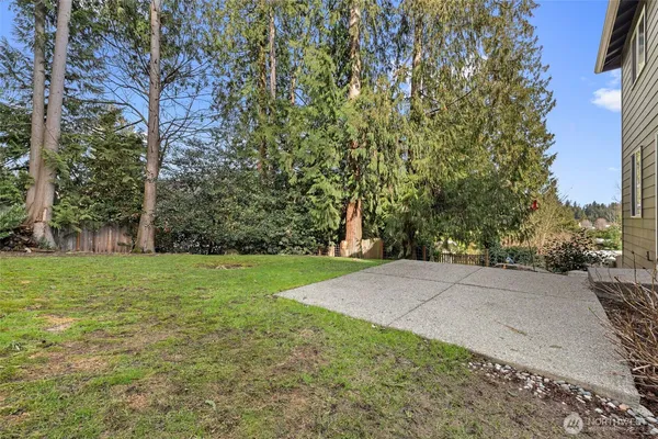 a view of a field with trees in the background