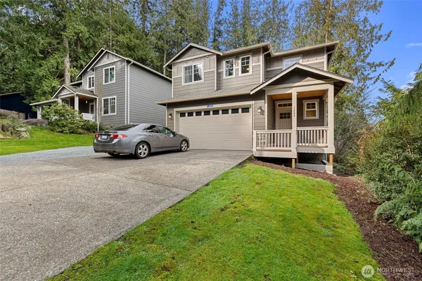 a front view of a house with a garden and yard