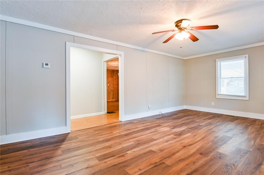 8196 Lakeview Drive Southwest Covington, GA 30014 - Photo 11 of 51 a view of an empty room with wooden floor and a window