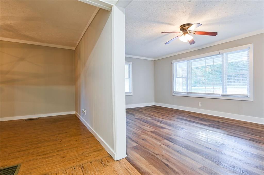8196 Lakeview Drive Southwest Covington, GA 30014 - Photo 12 of 51 a view of an empty room with wooden floor and a window