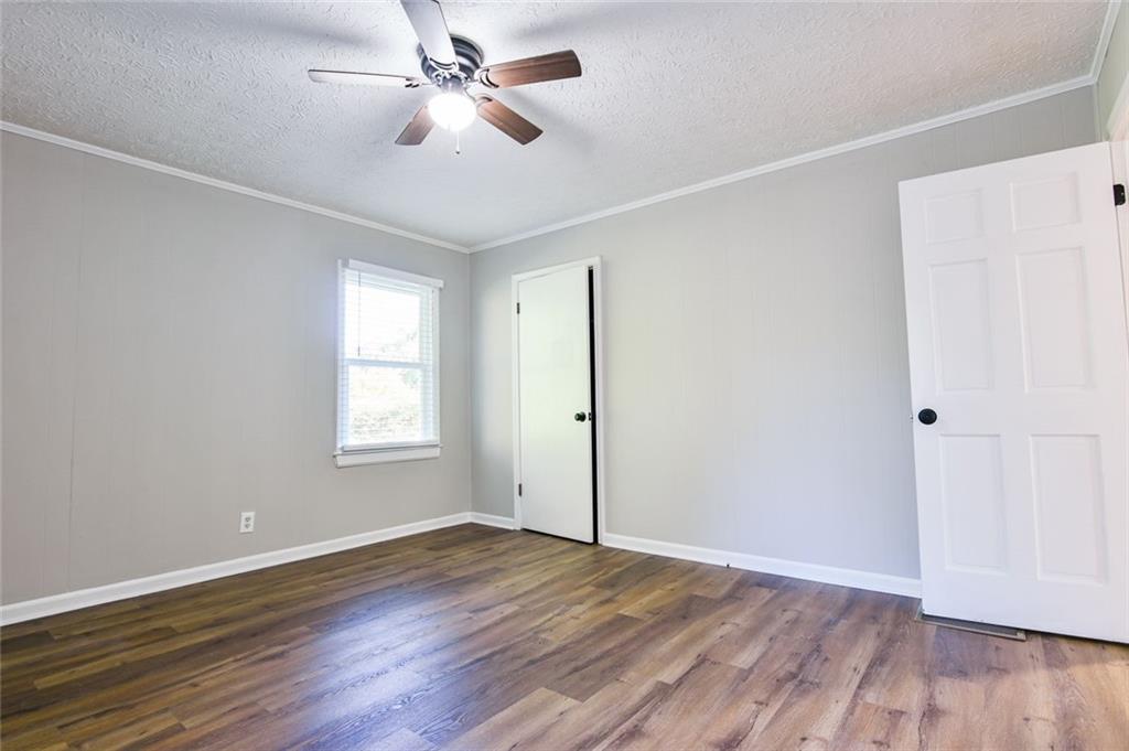 8196 Lakeview Drive Southwest Covington, GA 30014 - Photo 17 of 51 a view of empty room with wooden floor and fan