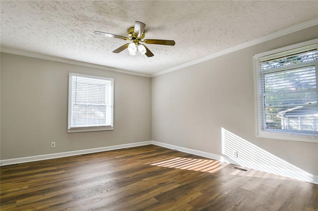 8196 Lakeview Drive Southwest Covington, GA 30014 - Photo 18 of 51 a view of an empty room with wooden floor and a window