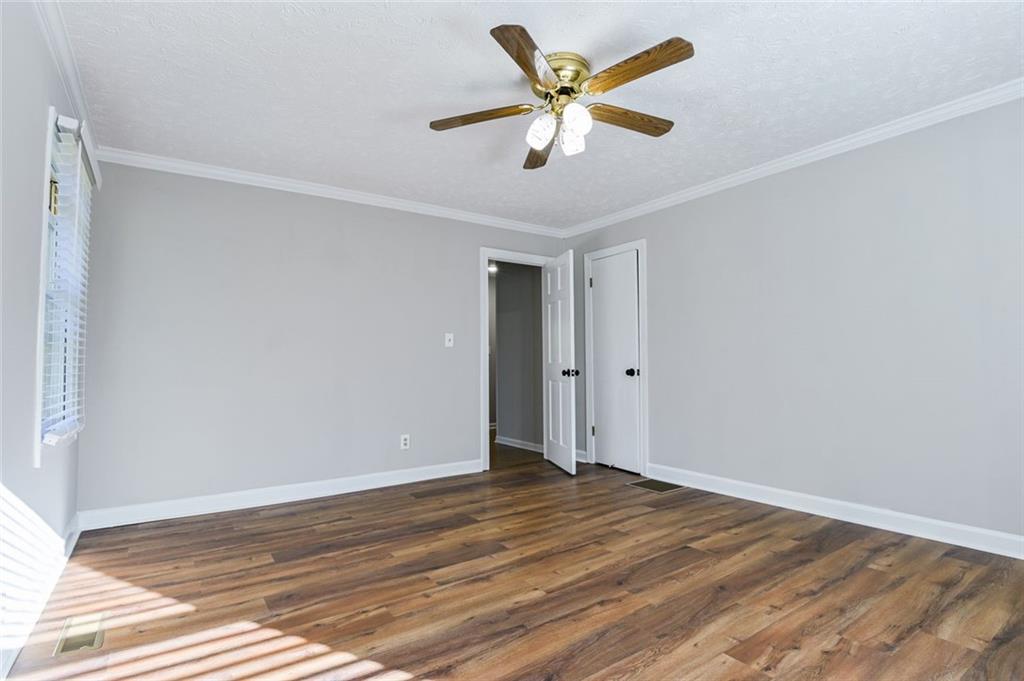 8196 Lakeview Drive Southwest Covington, GA 30014 - Photo 19 of 51 a view of a room with wooden floor and a ceiling fan