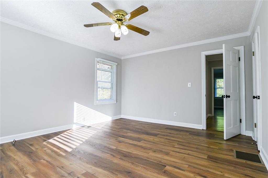 8196 Lakeview Drive Southwest Covington, GA 30014 - Photo 20 of 51 an empty room with wooden floor and windows