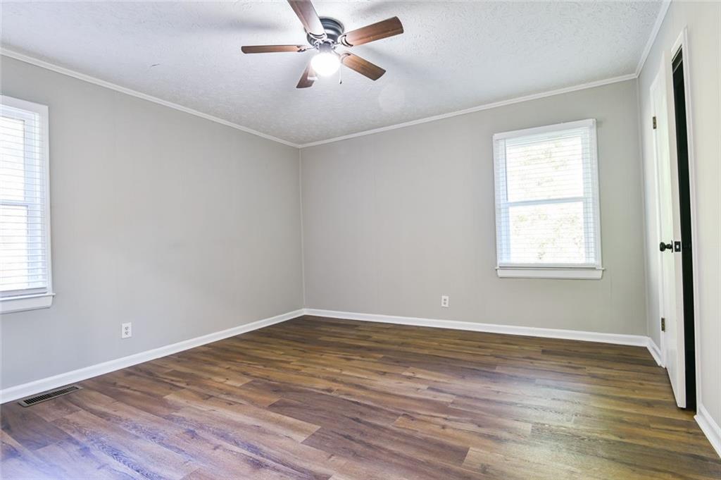 8196 Lakeview Drive Southwest Covington, GA 30014 - Photo 21 of 51 a view of empty room with wooden floor and fan