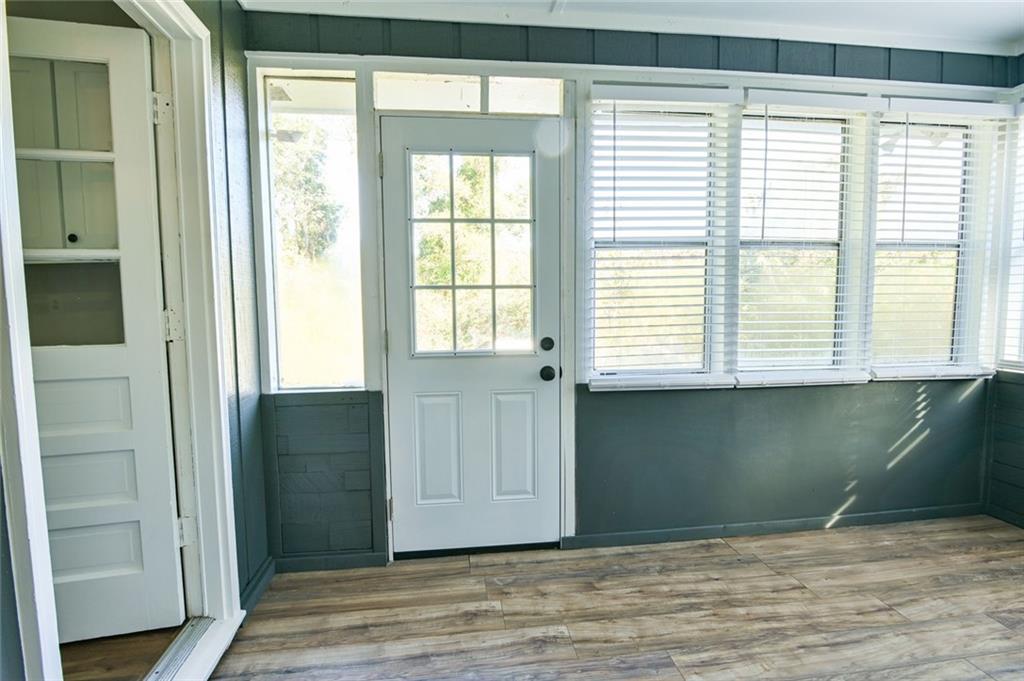 8196 Lakeview Drive Southwest Covington, GA 30014 - Photo 38 of 51 a view of an empty room with a window and a kitchen
