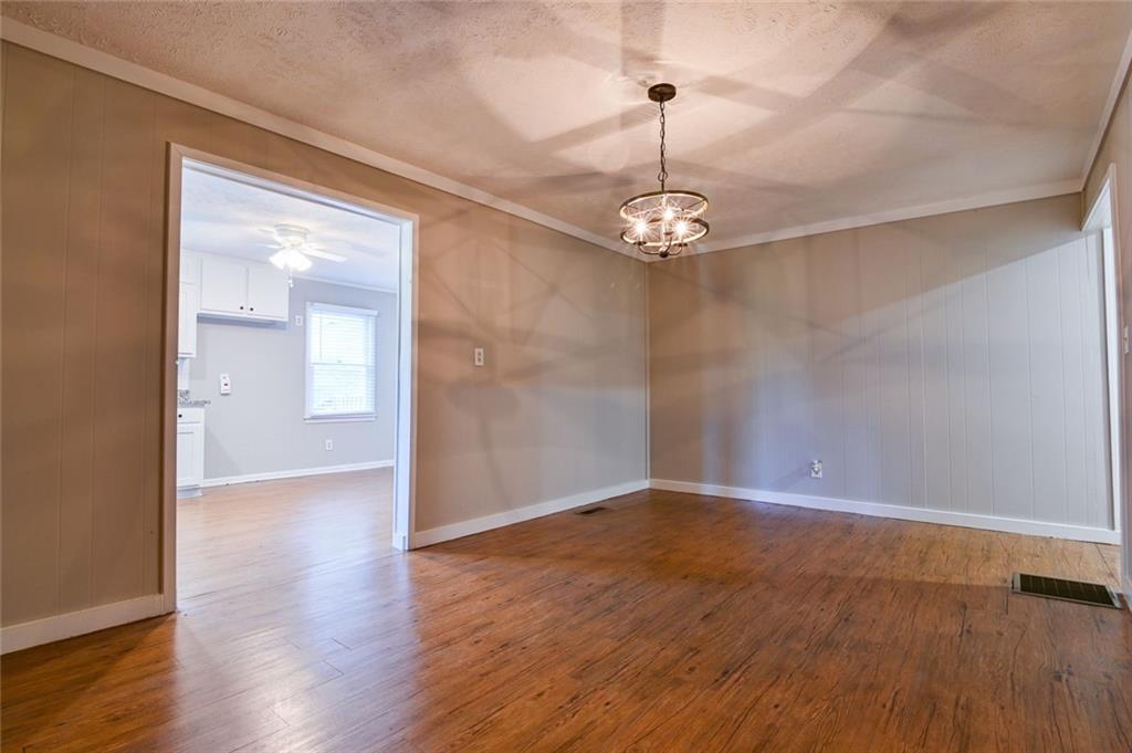 8196 Lakeview Drive Southwest Covington, GA 30014 - Photo 9 of 51 a view of empty room with wooden floor chandelier and glass door