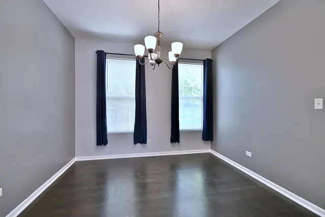 a view of a chandelier fan and wooden floor