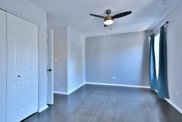 a view of an empty room with a ceiling fan