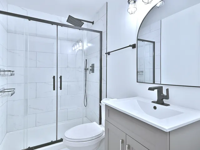 a bathroom with a sink toilet and shower