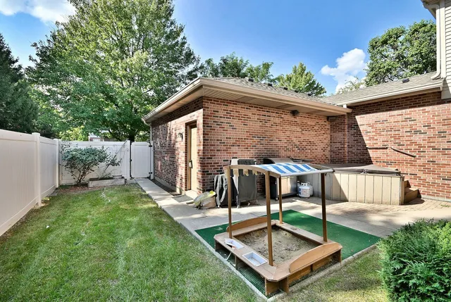 a view of house with yard outdoor seating and garage