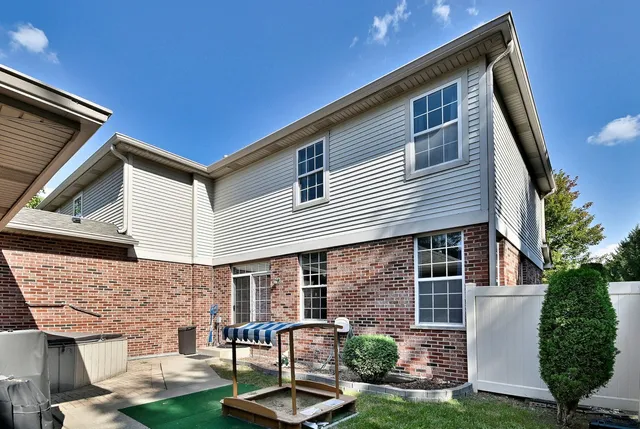 a backyard of a house with barbeque oven