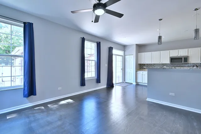 wooden floor in an empty room with a kitchen