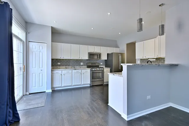 a kitchen with stainless steel appliances a refrigerator sink and cabinets
