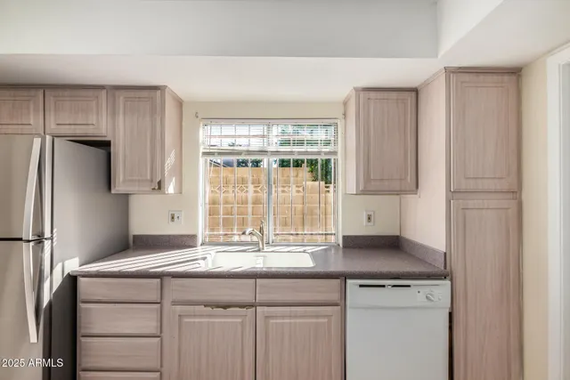 a kitchen with a sink and a refrigerator