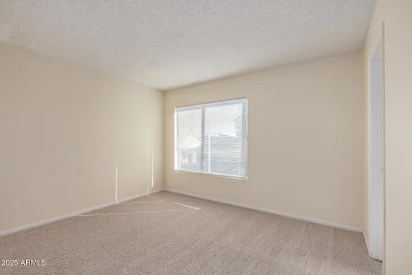 a view of an empty room and closet area