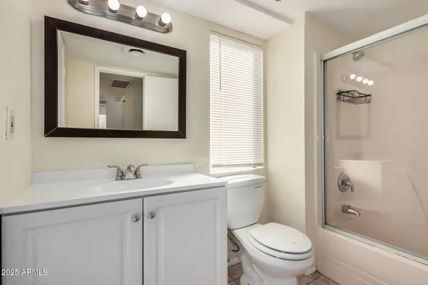 a bathroom with a glass shower door