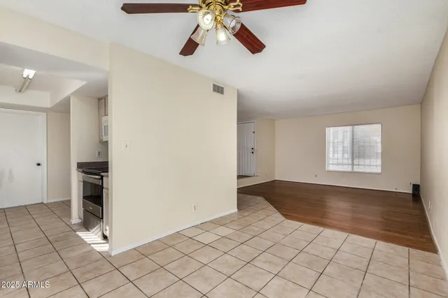 a kitchen with granite countertop a refrigerator and a stove top oven