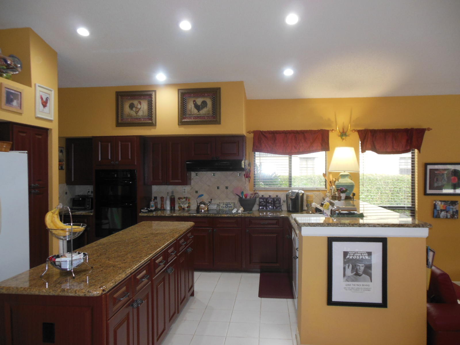 2653 Northwest 48th Street Boca Raton, FL 33434 - Photo 9 of 56 a kitchen with stainless steel appliances granite countertop a sink stove and cabinets