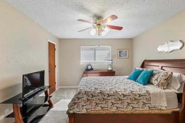 a bedroom with a bed and a flat screen tv