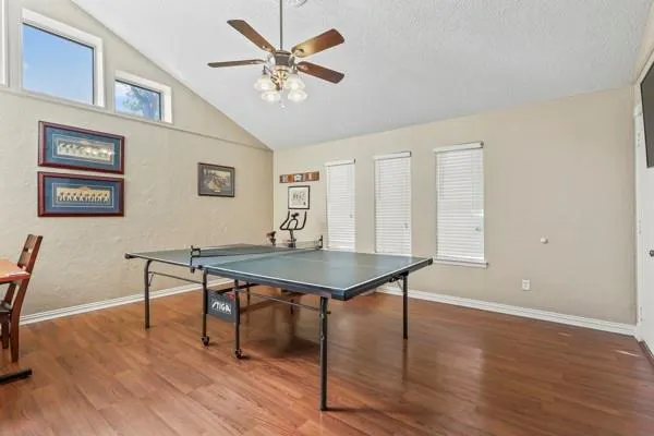 a room with furniture pool table and wooden floor