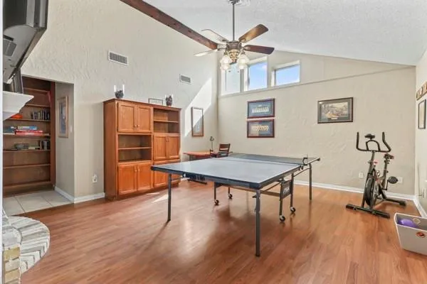 a dining room with wooden floor and a refrigerator