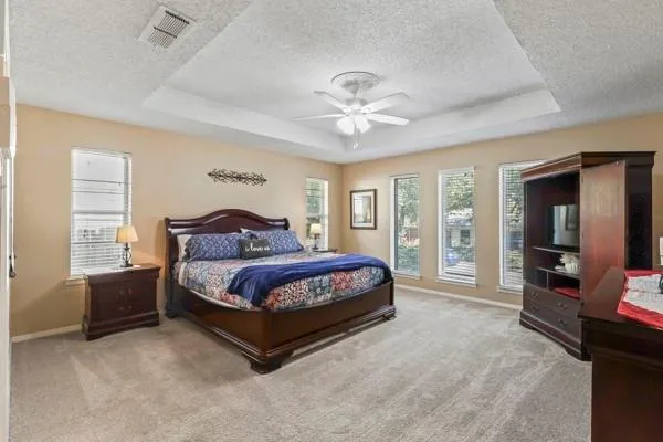 a spacious bedroom with a bed and glass wall