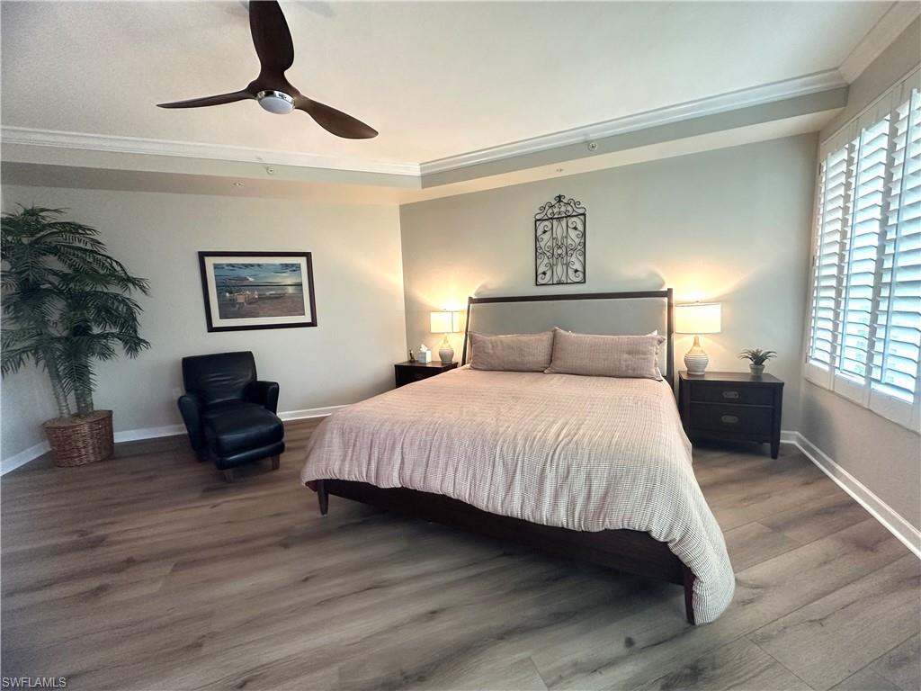 325 Dunes Boulevard, Unit 306 Naples, FL 34110 - Photo 19 of 40 a bedroom with a bed and wooden floor