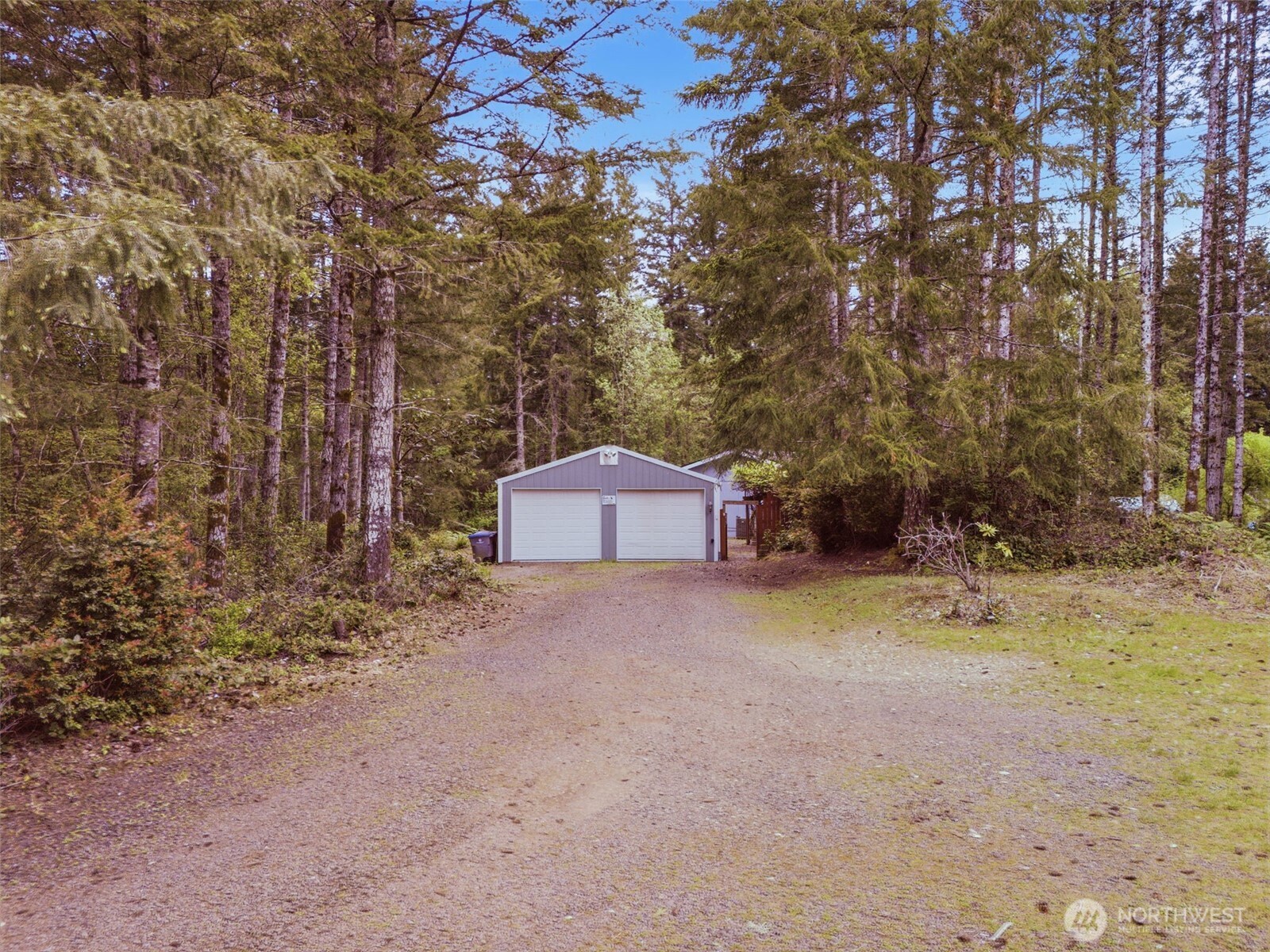 71 East Richardson Road Belfair, WA 98528 - Photo 26 of 31 a backyard of a house with a yard and garage