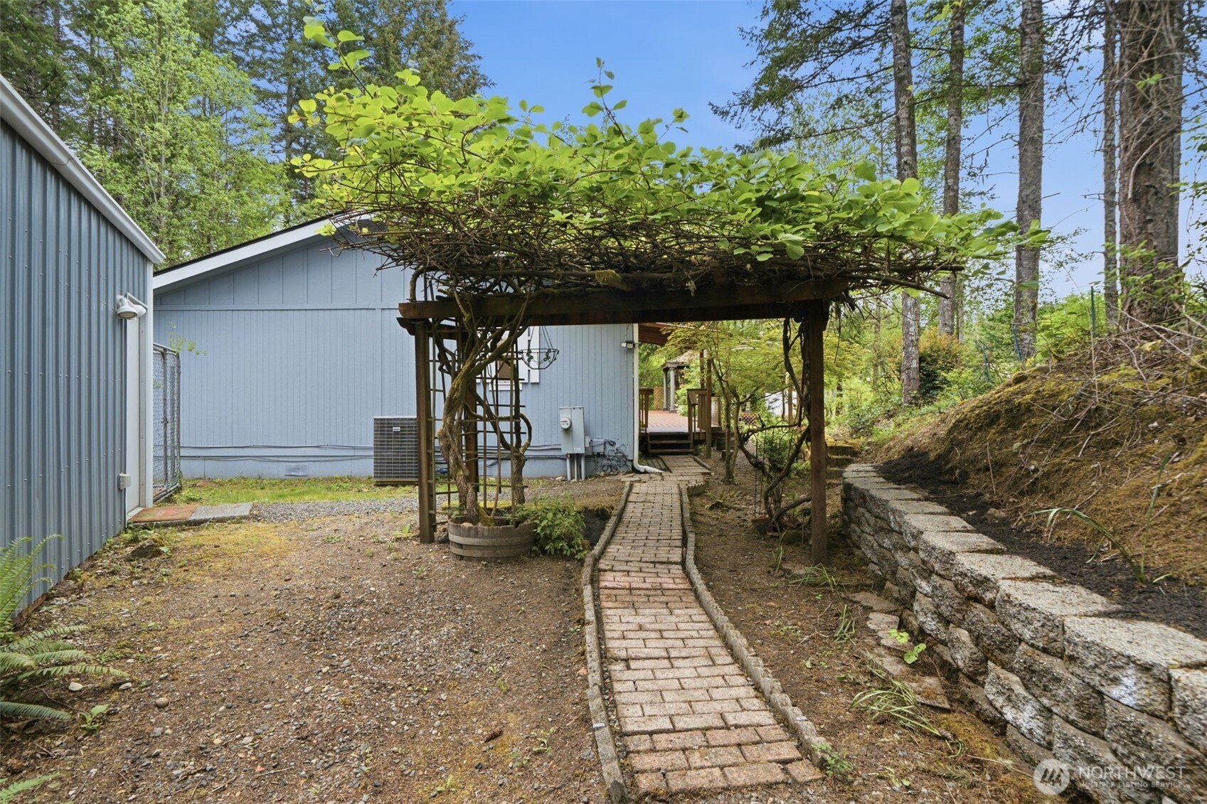 71 East Richardson Road Belfair, WA 98528 - Photo 3 of 31 a backyard of a house with table and chairs