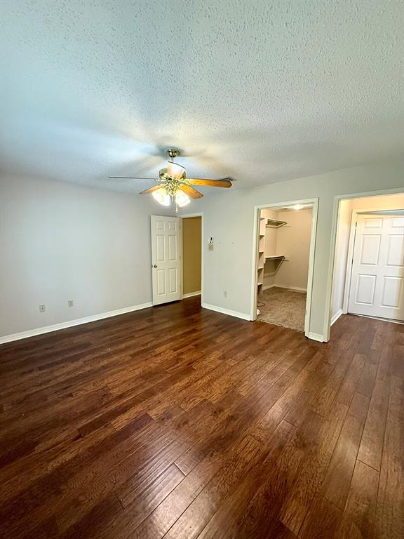 11535 Timber Ridge Drive Keithville, LA 71047 - Photo 25 of 39 an empty room with wooden floor and windows