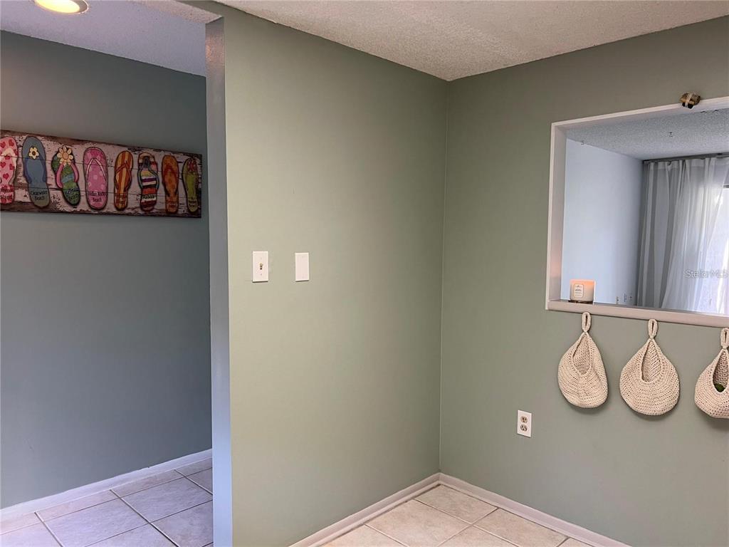1100 East Bay Drive, Unit 35 Largo, FL 33770 - Photo 12 of 34 a view of a hallway with paintings on the wall