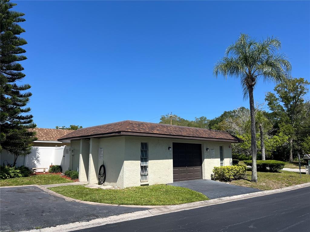 1100 East Bay Drive, Unit 35 Largo, FL 33770 - Photo 21 of 34 a front view of a house with a yard and garage