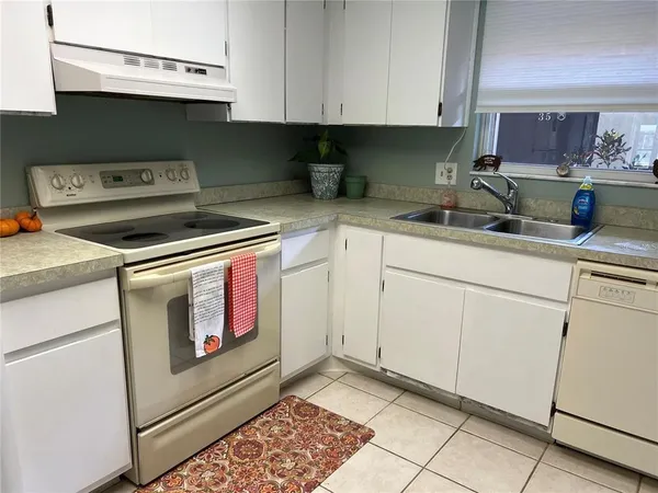 a kitchen with stainless steel appliances granite countertop a sink stove and cabinets