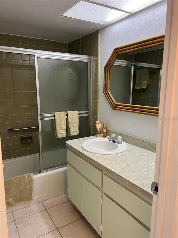 1100 East Bay Drive, Unit 35 Largo, FL 33770 - Photo 9 of 34 a bathroom with a sink a mirror and bathtub