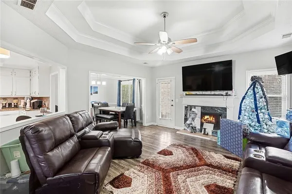 a living room with furniture a flat screen tv and a fireplace