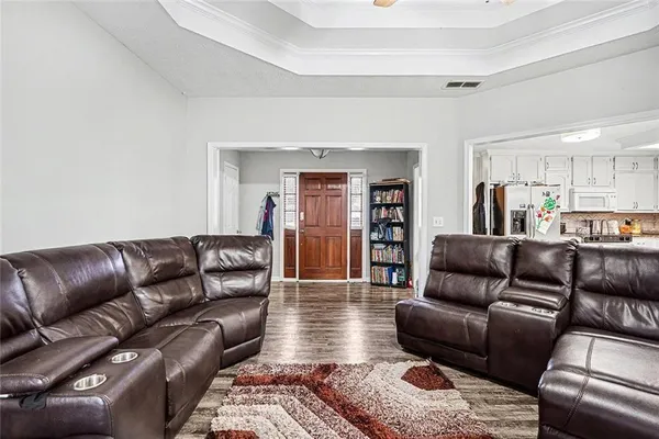a living room with furniture a flat screen tv and a fireplace